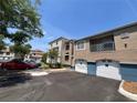 Exterior view of a condo with garage, balcony, and neatly arranged parking space on a sunny day at 7320 Westpointe Blvd # 531, Orlando, FL 32835