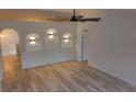 Bright living area with unique recessed lighting, modern fan, and light wood-look floors at 901 Cascades Park Trl, Deland, FL 32720