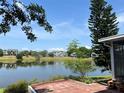 Picturesque lake view from the brick paved patio with mature trees and lush landscaping at 904 W Charing Cross Cir, Lake Mary, FL 32746