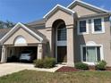 Charming two-story stucco home with a two-car garage; car parked inside at 904 W Charing Cross Cir, Lake Mary, FL 32746