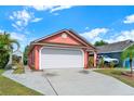 Charming single Gathering home with a well maintained lawn, attractive landscape and a two car garage at 9668 Hollyhill Dr, Orlando, FL 32824