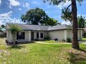 Charming single-story home with a well-manicured lawn and a classic neutral-toned facade, nestled under a bright sky at 1011 Chance Cv, Oviedo, FL 32765