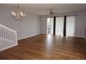 Spacious living room featuring wood floors, a ceiling fan, and sliding glass doors to let in light at 1034 Enclair St, Orlando, FL 32828