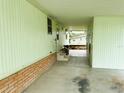 Covered carport area with access to the house and backyard at 106 Azalea Trl, Leesburg, FL 34748