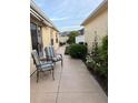 Serene backyard patio with comfortable seating and vibrant flower beds, perfect for outdoor relaxation at 1130 Pelion Pl, The Villages, FL 32162