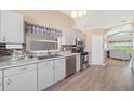 Functional kitchen with stainless steel appliances, and views of the dining and living spaces at 115 Henue Ct, Davenport, FL 33896