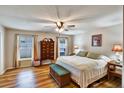 Cozy bedroom with hardwood floors, a ceiling fan, and abundant natural light from large windows at 130 Evergreen Dr, Auburndale, FL 33823