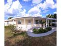 Inviting home with a covered entrance, manicured landscaping, and an attached carport for convenient parking at 15 Ne 63Rd Ct, Ocala, FL 34470