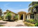 Elegant home featuring a tile roof, stone accents, lush landscaping, and a circular driveway at 1502 Hempel Ave, Windermere, FL 34786
