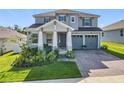 Charming two-story home boasts a manicured lawn and a two-car garage at 2044 Keystone Pass Blvd, Minneola, FL 34715