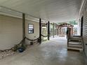 Covered outdoor space featuring a concrete floor and views of the backyard and gazebo at 24505 Snail Rd, Astor, FL 32102