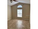 A bedroom with a vaulted ceiling, natural light and neutral paint, ready for furnishing at 2470 Augusta Way, Kissimmee, FL 34746
