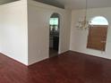 Bright dining room featuring hardwood floors, chandelier, and natural light from a large window at 2470 Augusta Way, Kissimmee, FL 34746