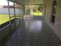 Screened patio with tile flooring, perfect for outdoor relaxation and entertainment at 2470 Augusta Way, Kissimmee, FL 34746