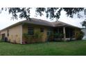 View of the back of the house with a screened-in lanai and a hose at 2913 Deerbrook Dr, Lakeland, FL 33811