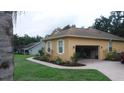 Single story home with an attached garage and walkway surrounded by landscaped garden at 2913 Deerbrook Dr, Lakeland, FL 33811