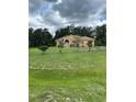 Sprawling lawn surrounds this single-story home with a welcoming arched entryway at 2913 Deerbrook Dr, Lakeland, FL 33811