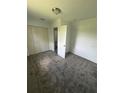 Bright bedroom featuring soft gray carpeting, and a spacious closet for storage at 2921 Crutchfield W Rd, Lakeland, FL 33805