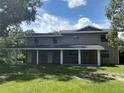 Inviting two-story home featuring a covered front porch, neutral siding, and well-maintained lawn at 2921 Crutchfield W Rd, Lakeland, FL 33805
