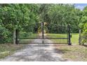 Ornate metal gate with a circular emblem adds elegance to the property's entrance at 3450 Ohio Ave, Sanford, FL 32773