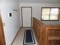Bright entryway with tile flooring, a wooden railing, and a large window providing natural light at 360 Kentia Rd, Casselberry, FL 32707