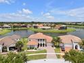 An aerial view of a stunning home next to a lake in a beautiful neighborhood at 3869 Shoreside Dr, Kissimmee, FL 34746