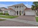 Beautiful two-story home featuring a brick driveway and a two-car garage at 3869 Shoreside Dr, Kissimmee, FL 34746