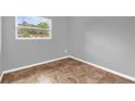 Bright bedroom features neutral walls, base molding, and complementary-colored floors at 5390 Botany Ct, Orlando, FL 32811