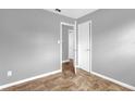 Bright bedroom featuring neutral walls, base molding, and complementary-colored floors at 5390 Botany Ct, Orlando, FL 32811