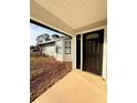 Inviting front porch with a view of the bay window, landscaping, and entry door at 5703 Sw 108Th St, Ocala, FL 34476