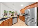 Bright kitchen featuring stainless steel appliances, granite counters, and tile flooring at 615 Maple Forest Dr, Orlando, FL 32825