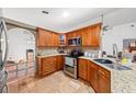 Functional kitchen with stainless steel appliances, granite countertops, and ample wood cabinetry at 615 Maple Forest Dr, Orlando, FL 32825