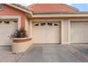 A view of the garage, which complements the townhome's warm-toned facade and tidy curb appeal at 7863 Sugar Bend Dr # 7863, Orlando, FL 32819