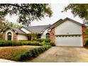 Charming single-story home featuring a brick and stucco facade, a two-car garage, and mature landscaping at 8044 Rural Retreat Ct, Orlando, FL 32819