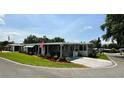 Inviting single-story home with an American flag and a well-kept lawn at 103 Poinsettia Cv, Leesburg, FL 34748