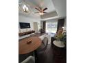 Bright living space with a dining area, modern furniture, and a view of the outdoor landscape at 1310 Seven Eagles Ct # 102, Reunion, FL 34747