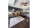 Cozy living room with modern decor, including a plush rug and a decorative desert mural at 1310 Seven Eagles Ct # 102, Reunion, FL 34747