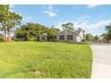 Well-maintained single-story home with a brick exterior, lush lawn, and an elongated driveway at 1330 Englewood Dr, St Cloud, FL 34772