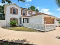 Charming two-story home showcases a large garage, well-kept landscaping, and a lovely white picket fence at 310 Dagama Ct, Kissimmee, FL 34758