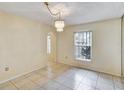 Bright living room featuring tile flooring, chandelier lighting and a view to the next room at 310 Dagama Ct, Kissimmee, FL 34758