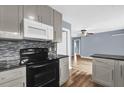 Updated kitchen features modern appliances, sleek countertops, and hardwood floors at 5806 Fernhill Dr, Orlando, FL 32808