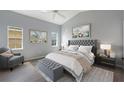Serene main bedroom featuring neutral tones, a plush bed, and ample natural light at 705 Ashton Dr, Davenport, FL 33837