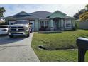 Charming single-story home with well-manicured front yard and long driveway at 959 Nancy Ct, Kissimmee, FL 34759