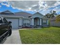 Charming single-story home featuring a well-maintained lawn and inviting entryway at 959 Nancy Ct, Kissimmee, FL 34759