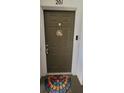 Condo front door, decorated with a welcome sign, and stylish door mat at 2307 Butterfly Palm Way # 201, Kissimmee, FL 34747