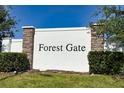 A sign for Forest Gate featuring brick and stone pillars at 1134 Forest Gate Cir, Haines City, FL 33844