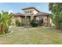 Beautiful home featuring a well-manicured lawn and tropical landscaping with vibrant plants at 2703 Gullane Ct, Kissimmee, FL 34746