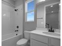 Bright bathroom with a shower-tub combination, white vanity, and a sleek, modern design at 1715 Sugarbelle Cir, Mascotte, FL 34753