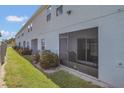 View of the exterior with a screened-in patio and well-maintained landscaping at 3359 Bellezza Ct, Kissimmee, FL 34746