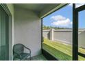 Relaxing screened-in patio provides a serene outdoor space with views of the fenced backyard and green grass at 3359 Bellezza Ct, Kissimmee, FL 34746